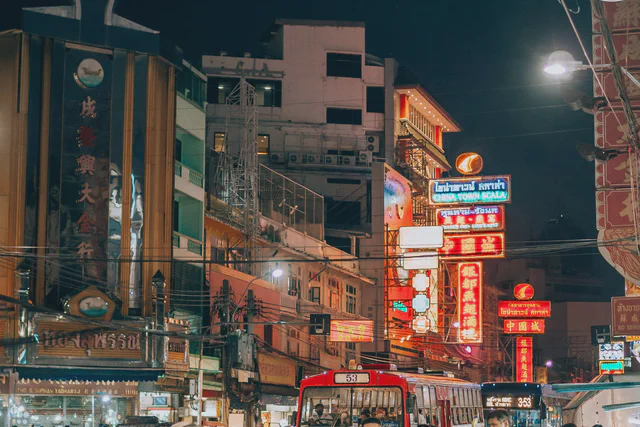 Neon signs, outdoor bars and evening crowds along Khao San Road in Bangkok