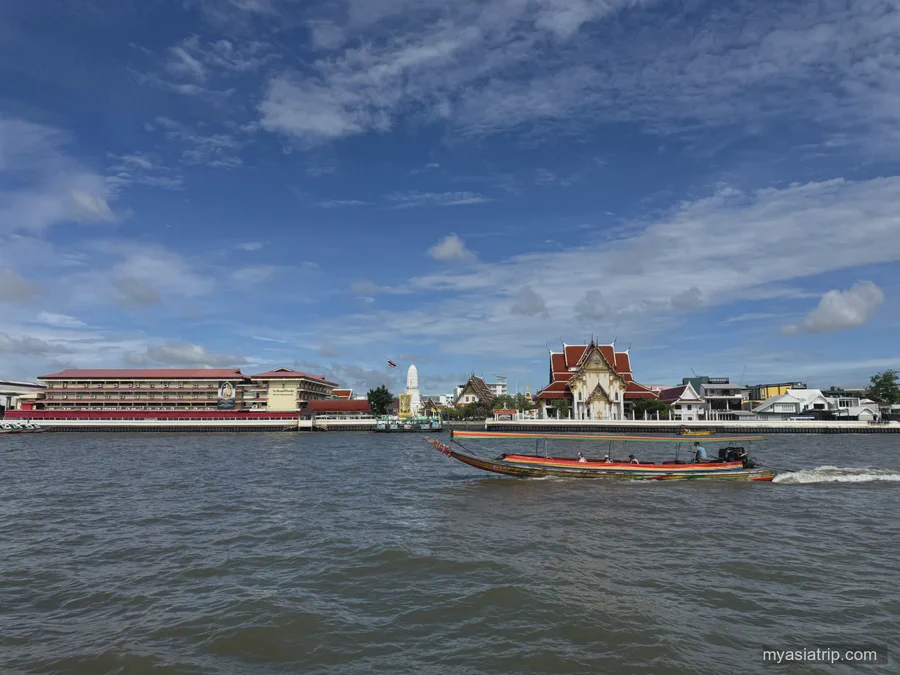 Long-tail boat crossing the Chao Phraya River in Bangkok