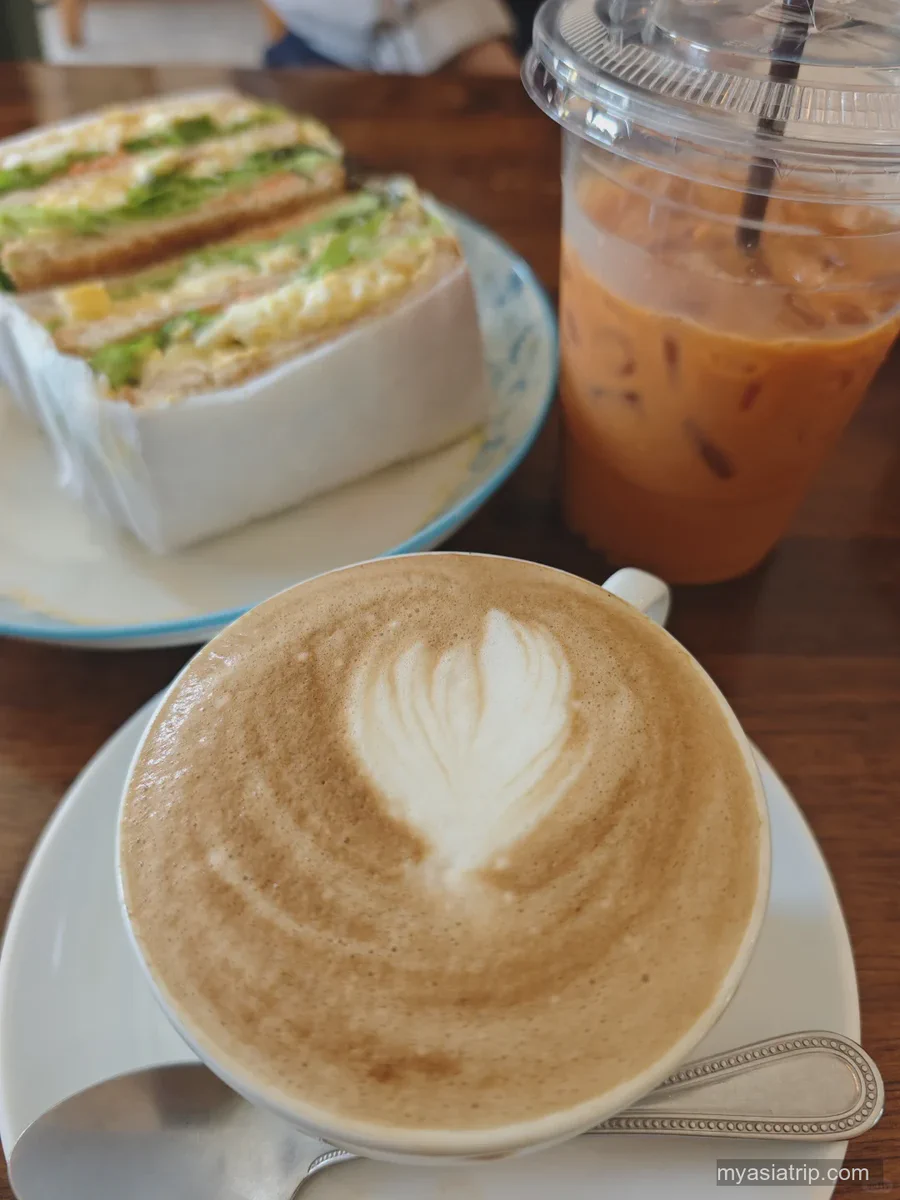 Coffee, iced tea and a breakfast sandwich on a Chiang Mai cafe table