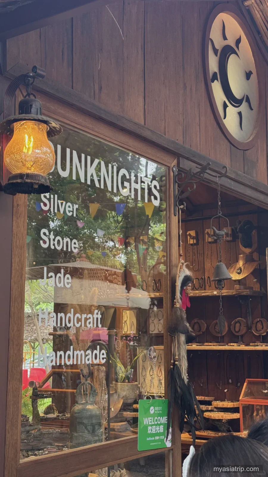 Small warmly lit bar entrance in Chiang Mai after dark
