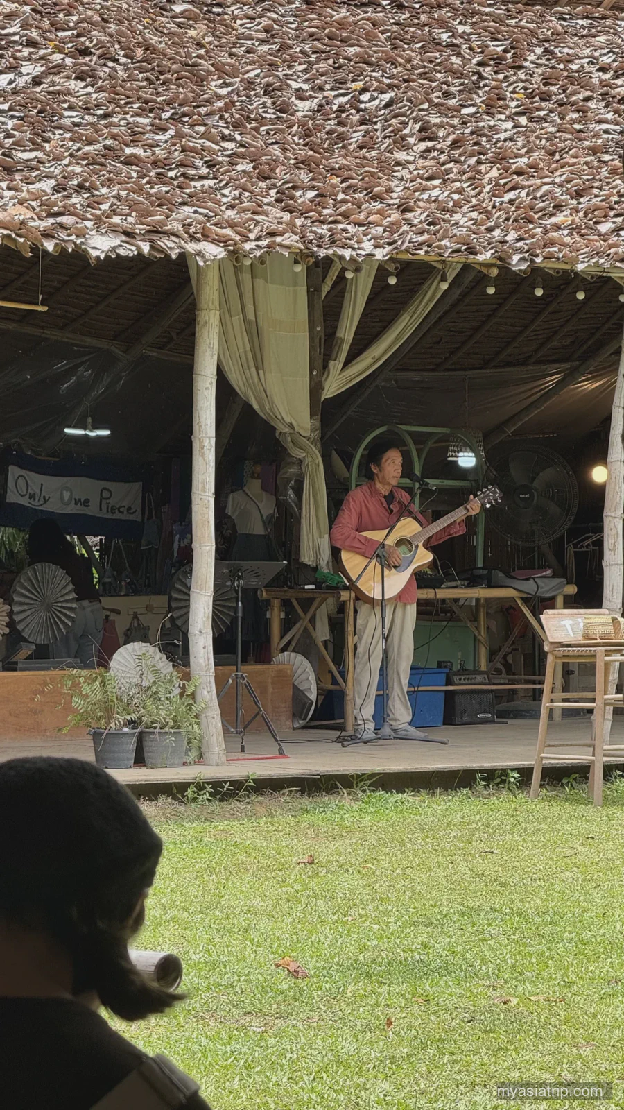 Live performer playing on a small outdoor stage in Chiang Mai