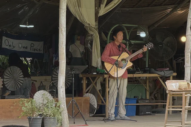 Live musician performing on an open-air stage in Chiang Mai