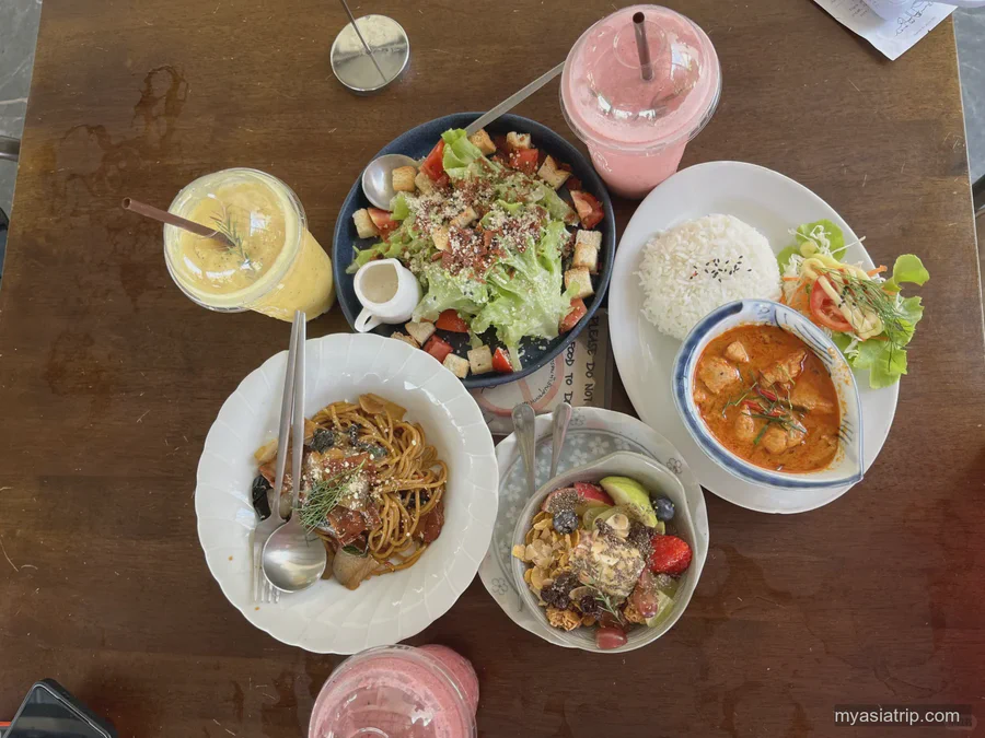 Northern Thai dishes and colorful drinks arranged on a table in Chiang Mai