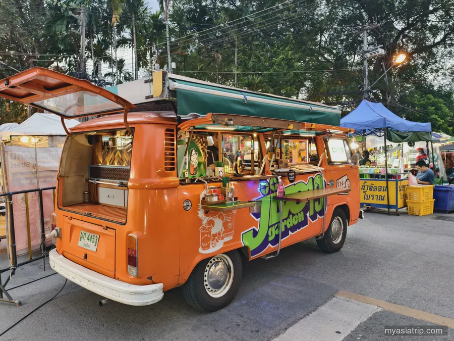 Orange tuk-tuk parked at an evening market in Chiang Mai