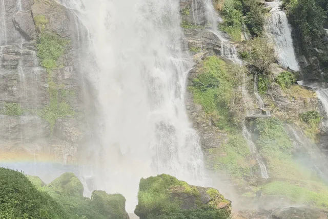 Large waterfall dropping through green forest on a Doi Inthanon day trip