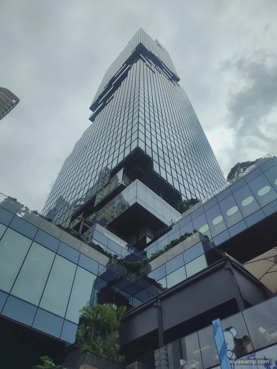 Mahanakhon tower viewed from street level beneath clouds