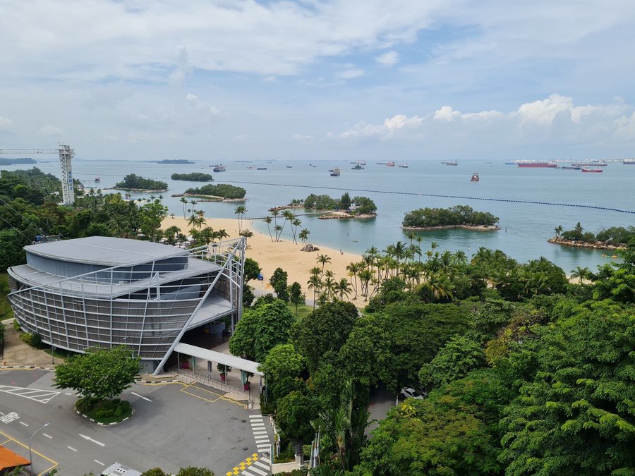 Visitors beside the water on Sentosa in Singapore